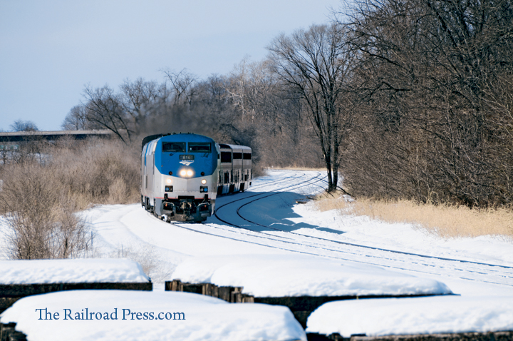 Amtrak P40 #816 leads the eastbound Capitol Limited through an s-curve in the snow