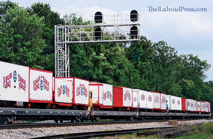 Ringling Brothers and Barnum & Bailey circus wagons on flatcars are seen on the circus train as it rolls under cantilever signals at Burke, Virginia, on the Southern Railway (VRE Virginia Railway Express) main line on May 1, 2017