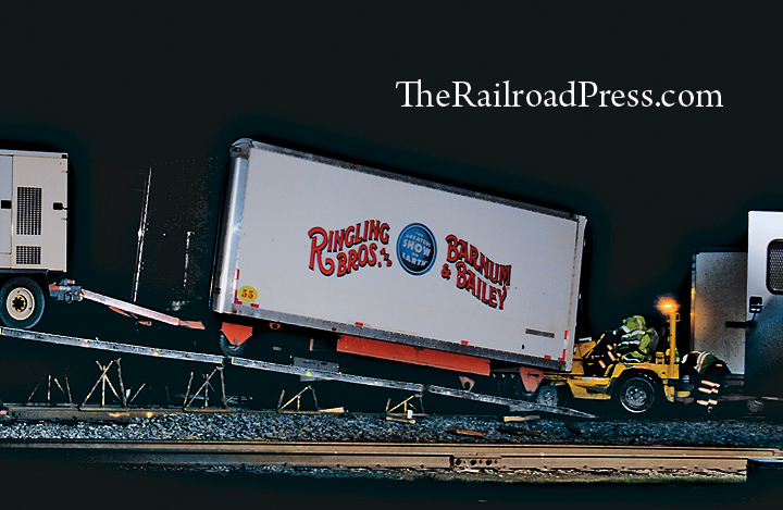 A bobcat pushes containers and circus wagons up a ramp and onto flatcars at night on the Ringling Brothers and Barnum & Bailey circus train after their performances at Wilkes-Barre, Pennsylvania, on May 1, 2016